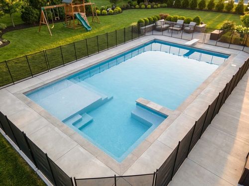 Rendering of family-friendly 16 by 34 foot rectangular pool with a wide shallow end, corner steps, a bench, and a small tanning ledge, light blue quartz water, brushed concrete deck, pool safety fence, lawn with a play set in the background