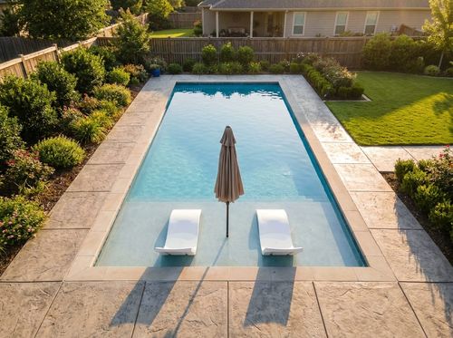 Rendering of a rectangular pool with a large tanning ledge holding two loungers and an umbrella
