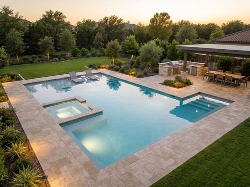 Rendering of a large rectangular pool with a tanning ledge, attached spa, and wide deck with an outdoor kitchen