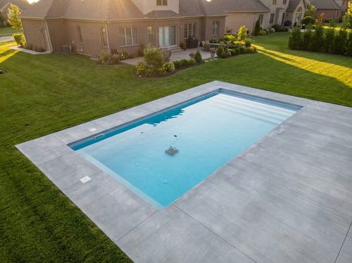 Rendering of a simple rectangular pool with a robotic cleaner on the floor and a clean concrete deck