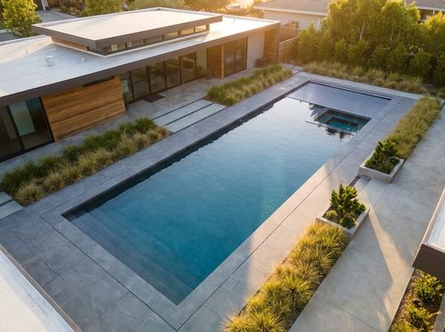 Rendering of a modern rectangular pool with flush coping, porcelain pavers, and a cover housing