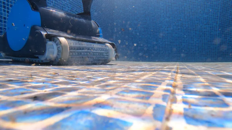 A robotic pool cleaner picking up debris during a hands-on pool test
