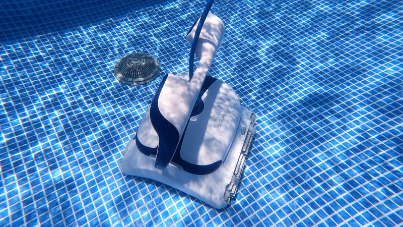 Dolphin Sigma robotic pool cleaner approaching a raised main drain