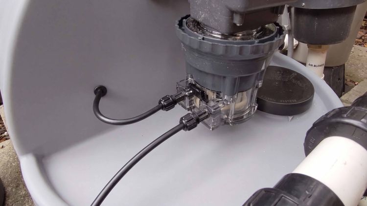 A Stenner peristaltic pump mounted above its vented solution tank — the classic DIY liquid chlorine injection build