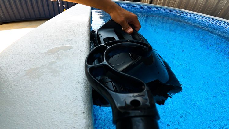 Hauling the robot out of the pool for charging