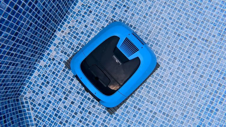 The EON 100 centered on the blue-tile pool floor during testing