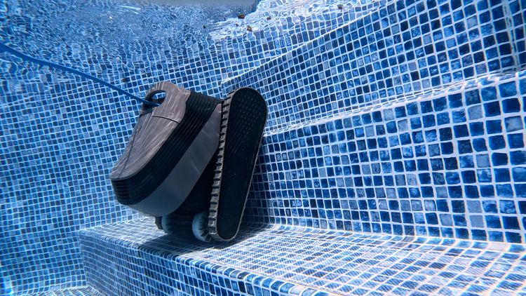 The Quantum gripping a step edge — one of the only corded robots that cleans stairs and shelves