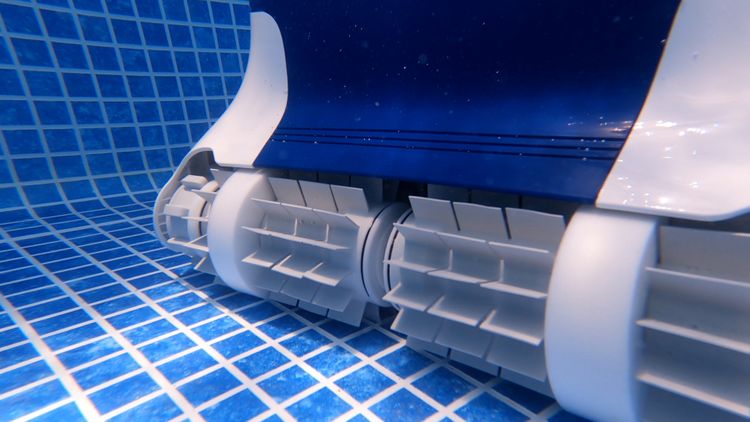 Closeup of the Dolphin Sigma's dual scrubbing brushes — designed to dig into gunite texture
