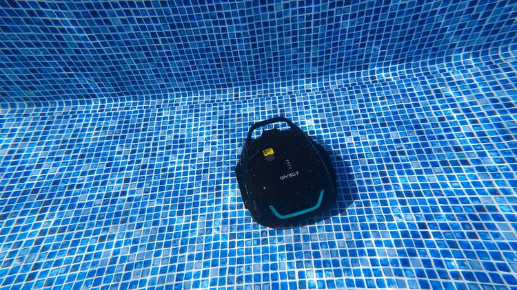 The Wybot A1 cordless pool cleaner working the pool floor during our testing