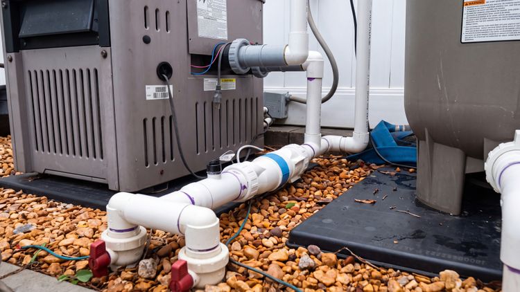 An OEM Hayward cell plumbed inline on the equipment pad — the last stop before water returns to the pool