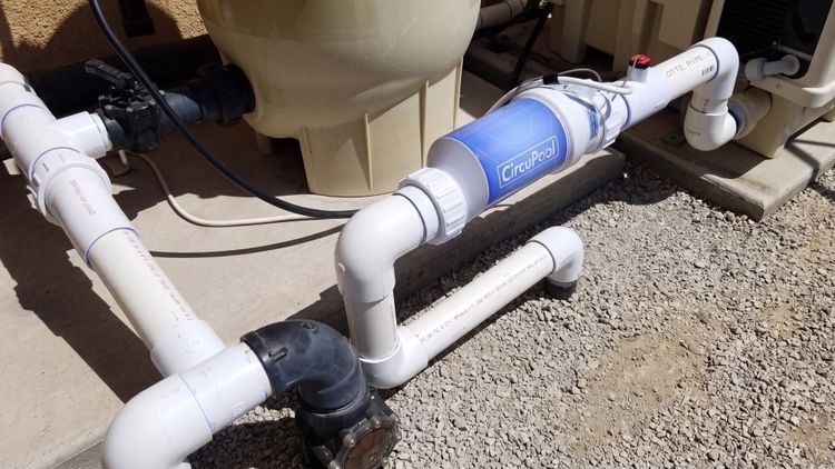 The cell installs as the last piece of equipment in the line — after the filter and heater, right before the water returns to the pool