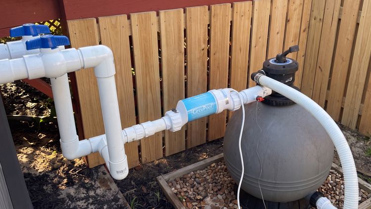 An above-ground salt system plumbed inline with a sand filter — a smaller, simpler install than the hard-plumbed in-ground setups